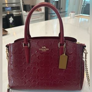 Beautiful shiny red Coach handbag with gold hardware. Used one time!